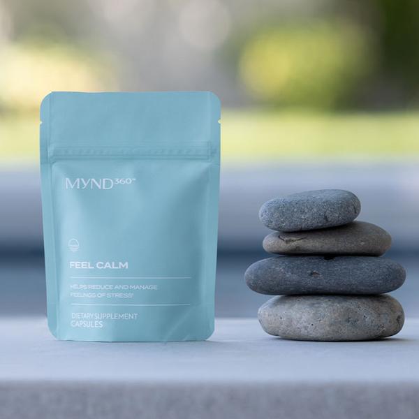 MYND360 Feel Calm dietary supplement  dietary supplement package with stones on a blurred natural background
